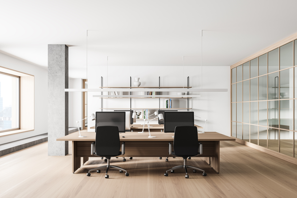 Interior of modern open space office with white and gray walls, wooden floor and big computer tables. 3d rendering