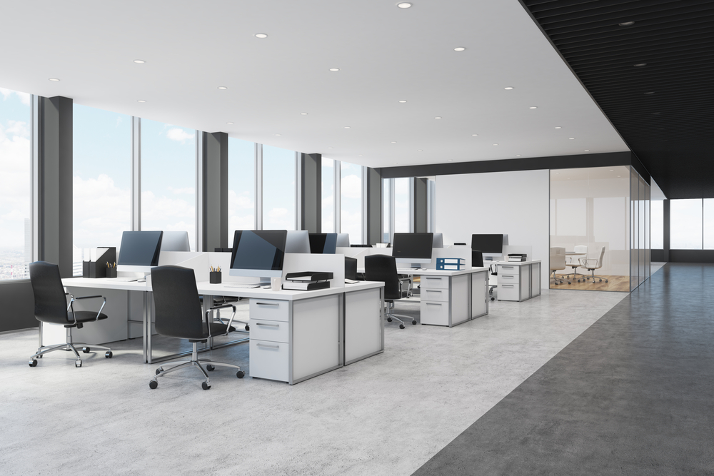 Side view of white and black open space office interior with rows of computer tables with desktops standing on them. 3d rendering mock up